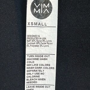 Athletic black tight fitting shirt with thumb holes on each sleeve.